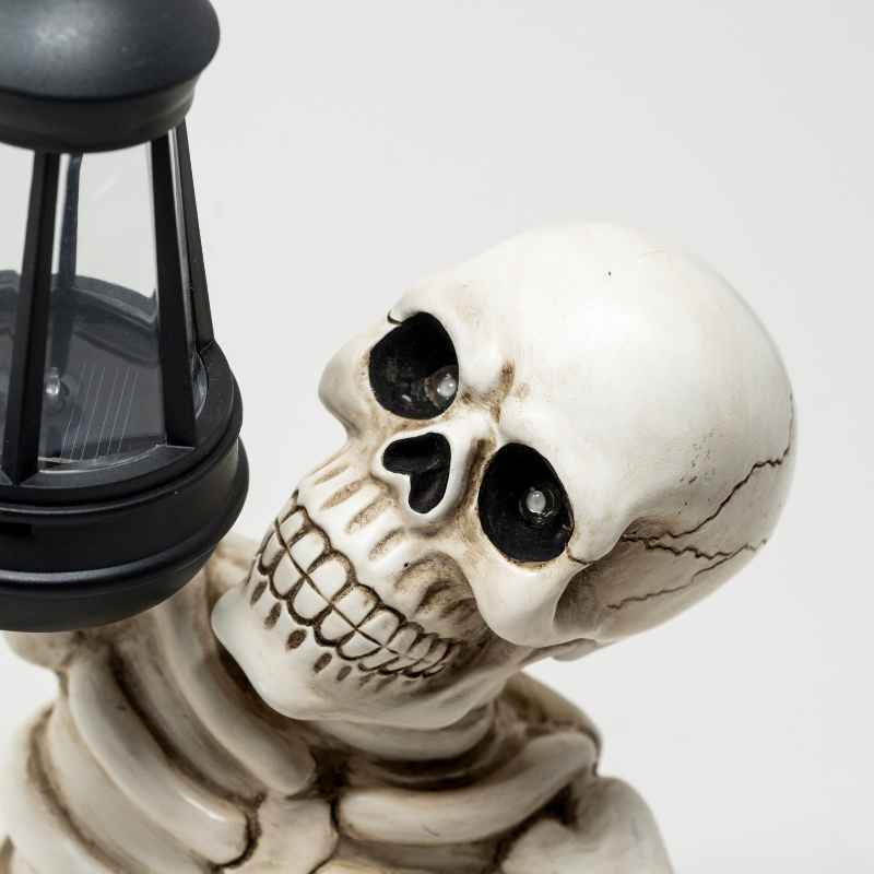 Solar Skeleton Groundbreaker Holding Lantern