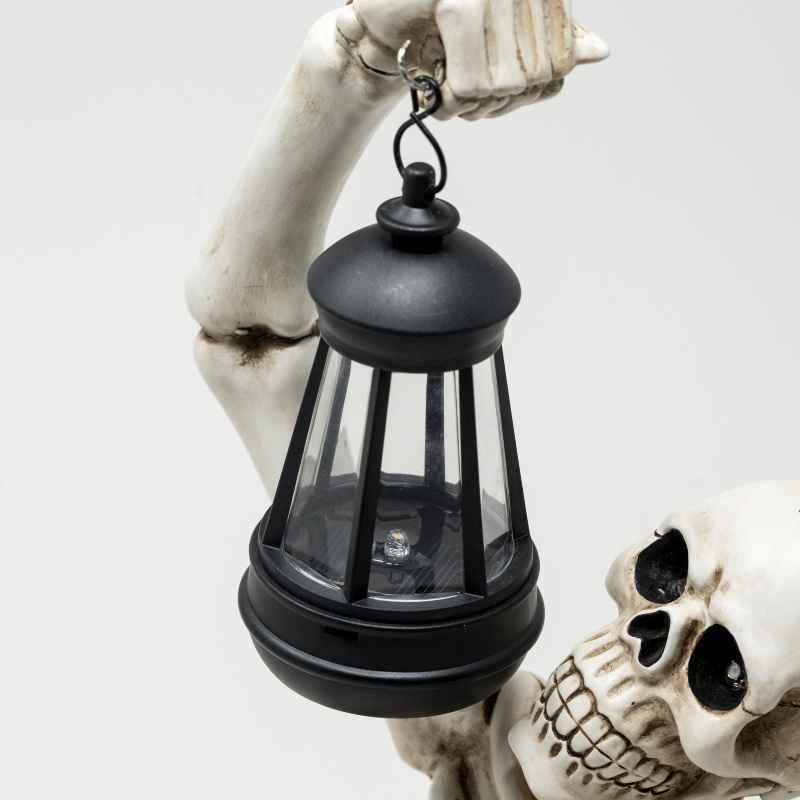 Solar Skeleton Groundbreaker Holding Lantern