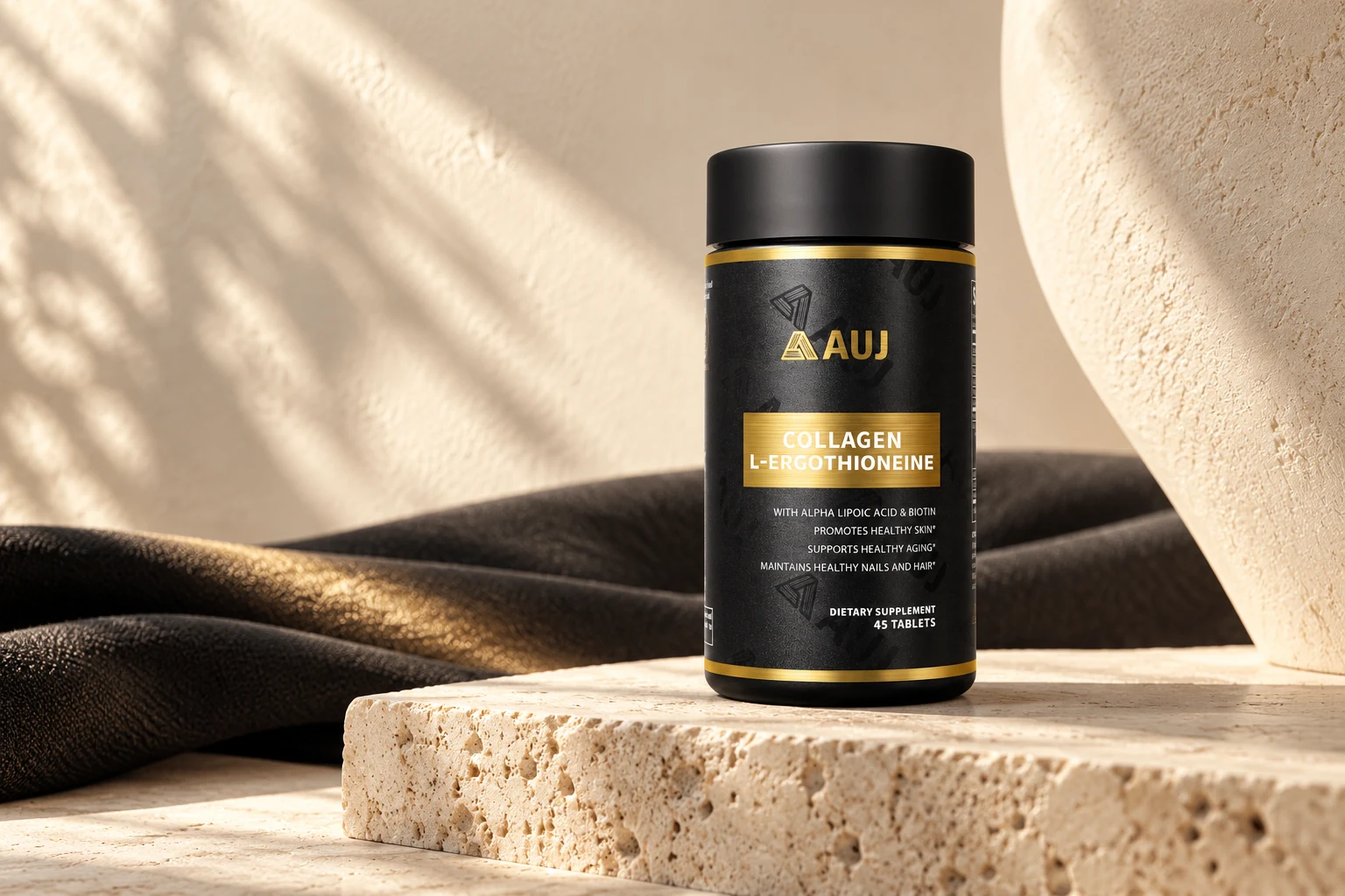 AUJ Black Gold Bottle on warm travertine with sculptural ivory and charcoal textures