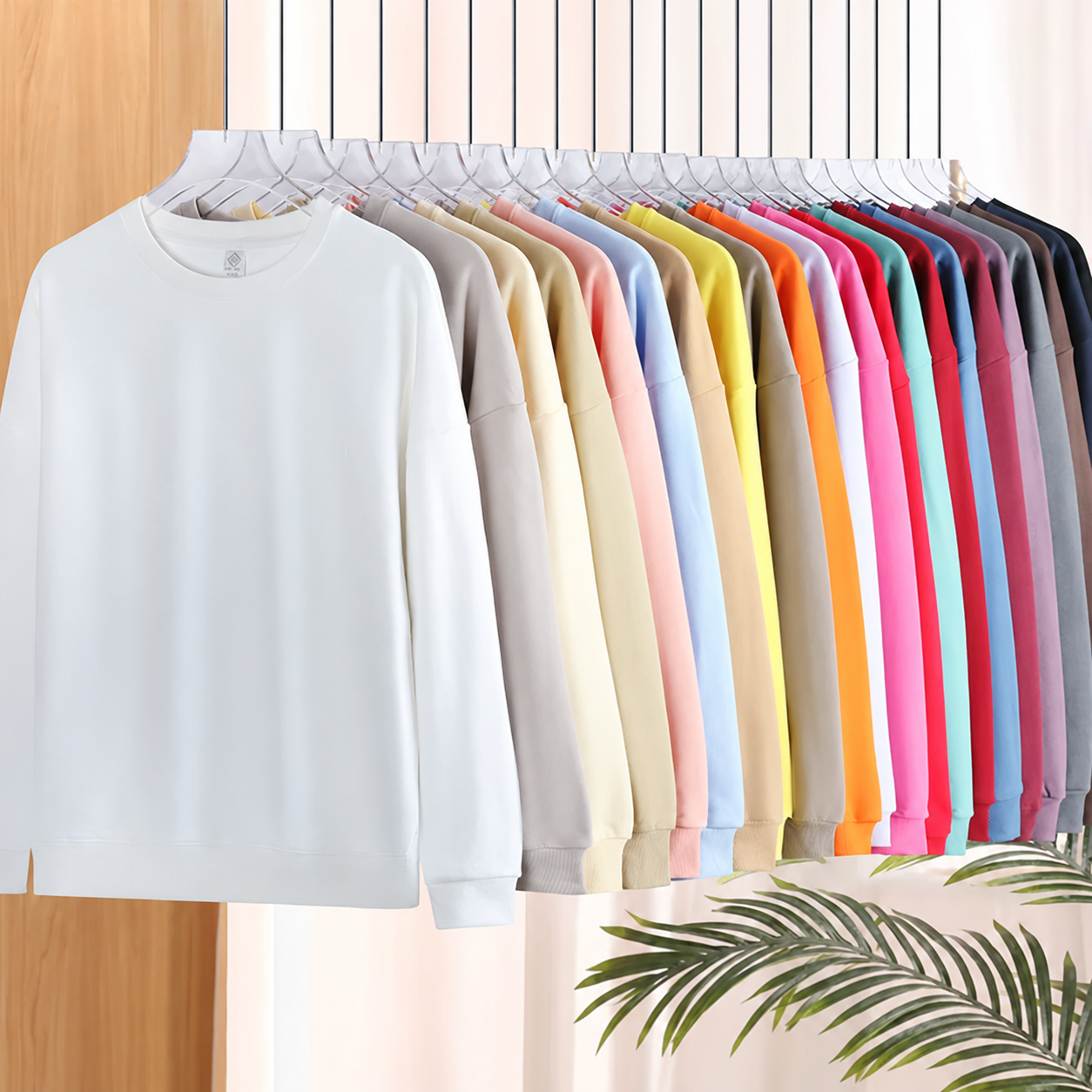 Plain crew-neck sweatshirts on a clothing rack; supplier advertising banner removed with AI assistance.