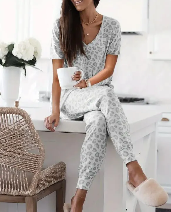 Women's V-NeckLeopard Print Loungewear Set. This relaxed-fit two-piece features a short-sleeve top and pants for effortlessly chic, casual comfort.