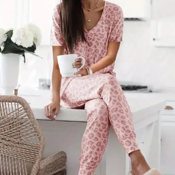 Women's V-NeckLeopard Print Loungewear Set. This relaxed-fit two-piece features a short-sleeve top and pants for effortlessly chic, casual comfort.