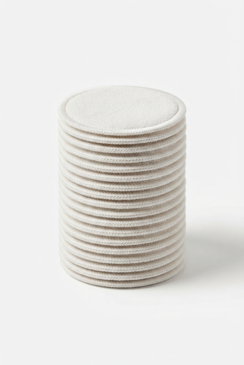 Whitesmoke stack of reusable makeup remover pads on matte off-white background