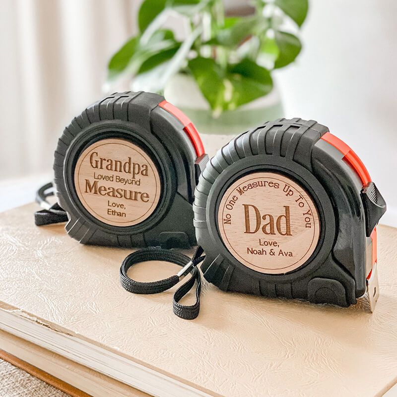Father's Day Tape Measure Wooden Engraving - No One Measures Up on a wooden surface