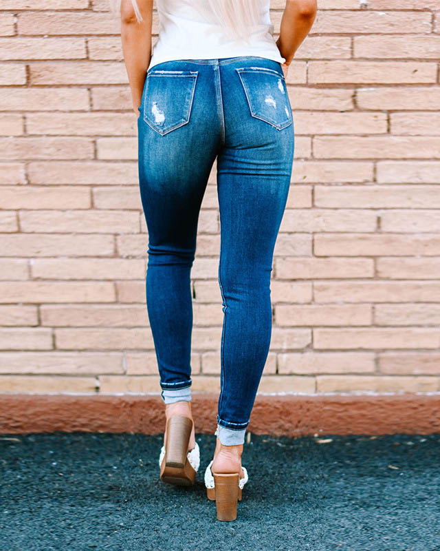 Pantalones vaqueros ajustados rasgados de mujer con botones lavados aj