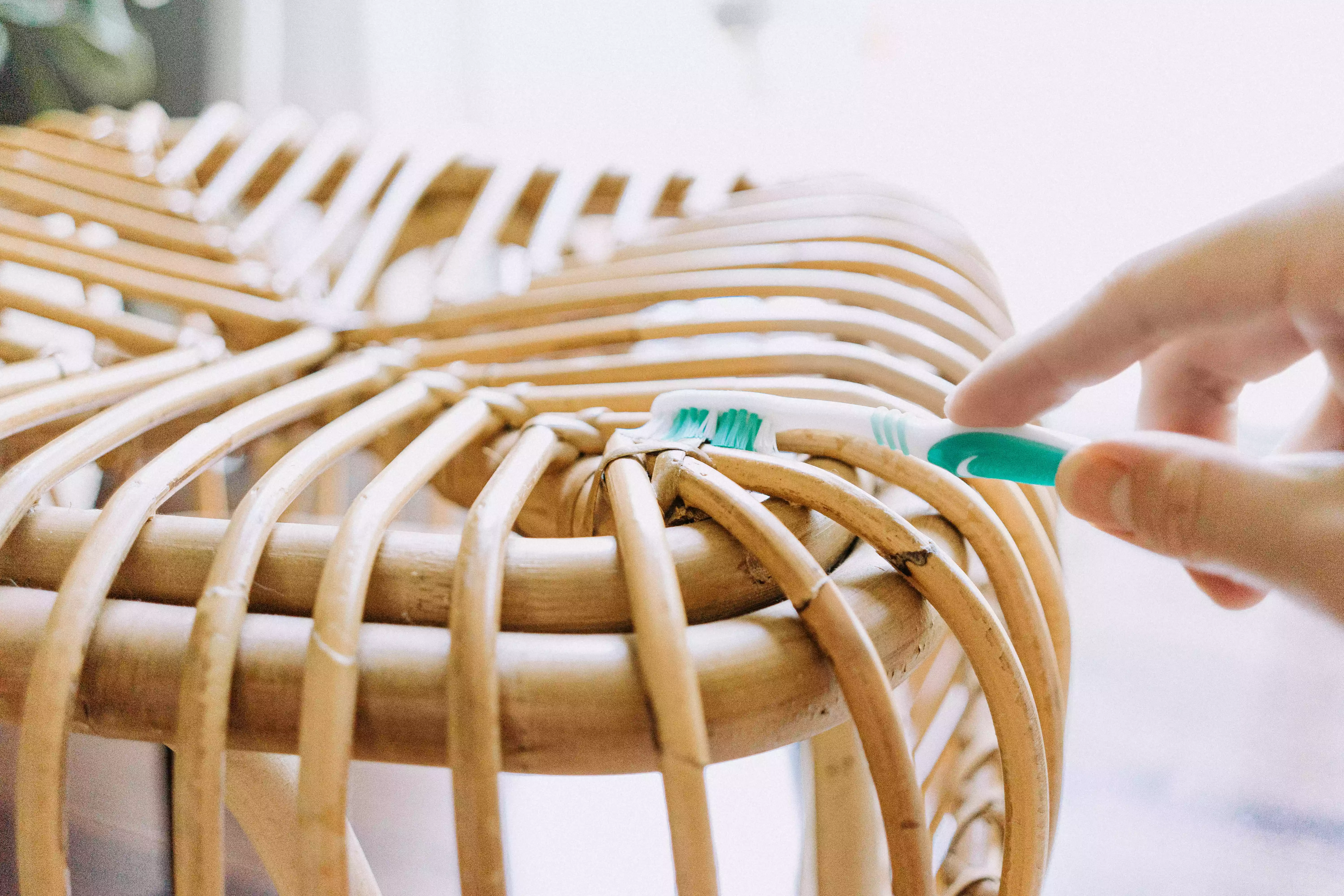 using a toothbrush to scrub any solids off of the furniture