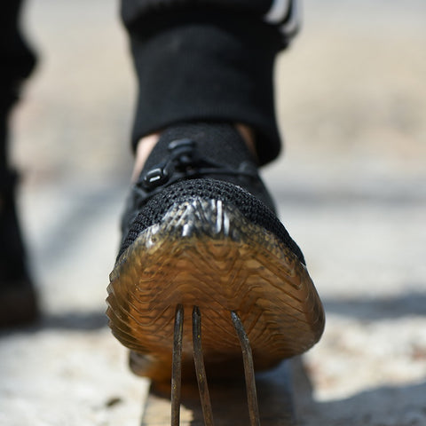 Front view of a person attempting to step on nails 480 x 480