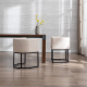 Industrial upholstered dining chairs with beige fabric upholstery and black metal legs, rear view in dining room setting