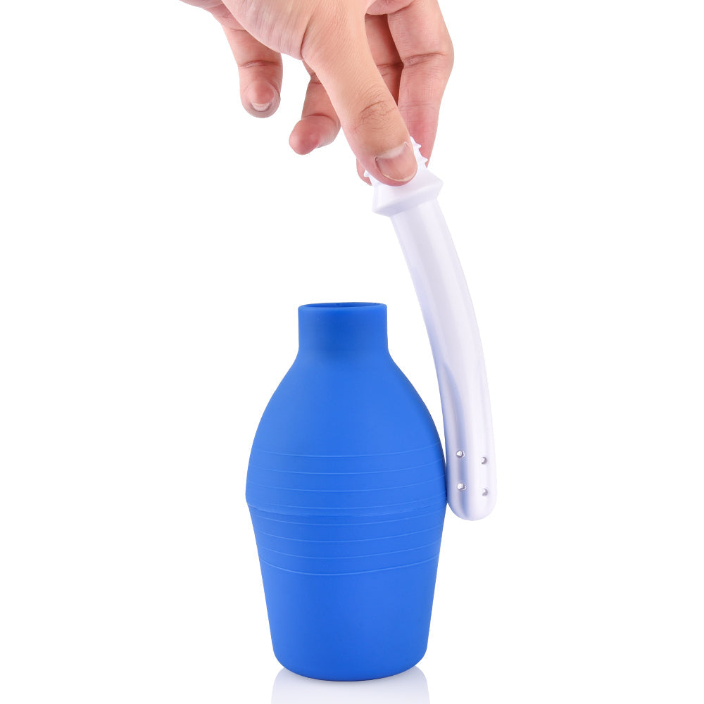 Hand holding the nozzle of a blue bulb-shaped portable sex doll washer made from elastic memory silicone material to clean sex dolls efficiently.