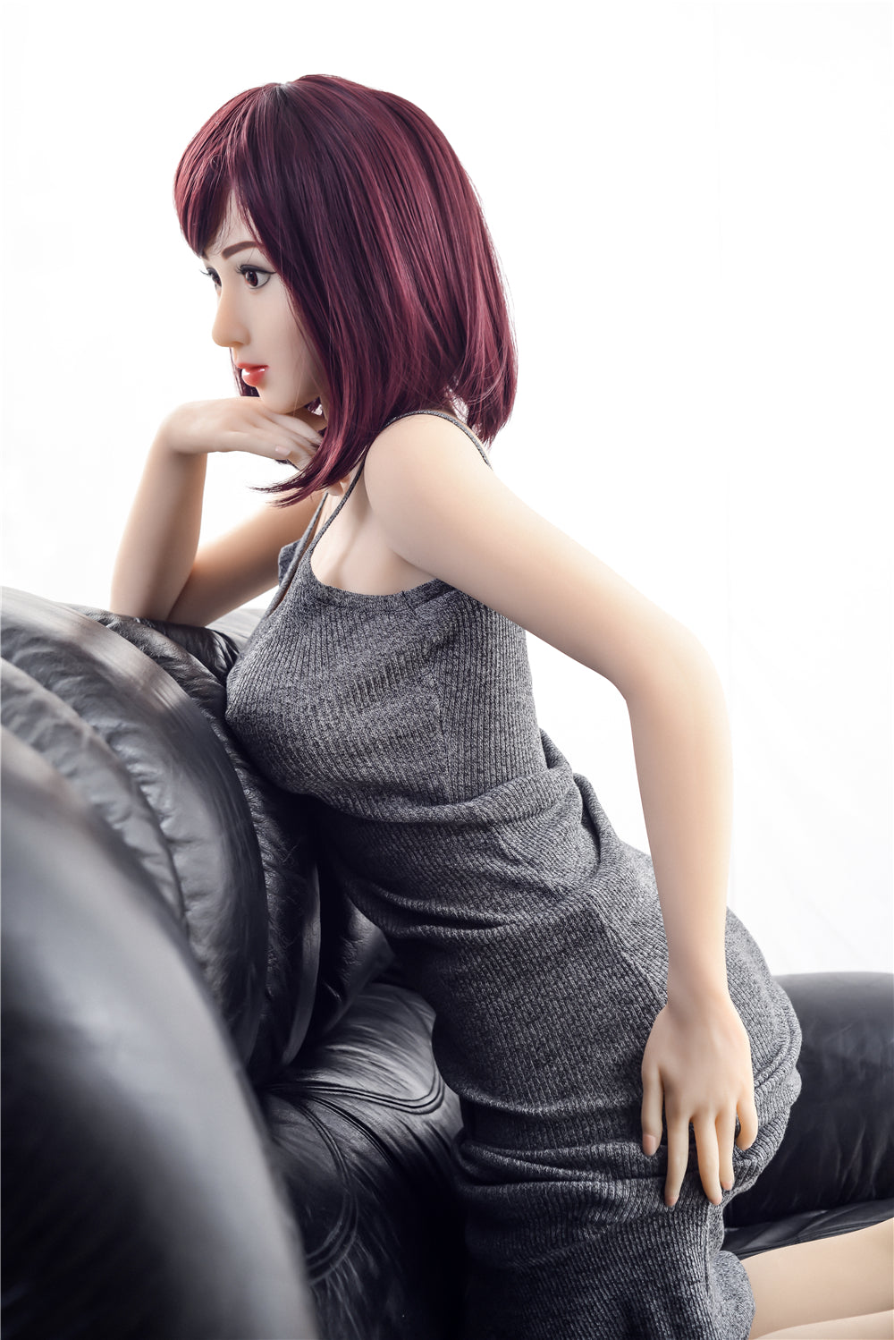 160cm TPE doll Jennifer, resting on black sofa