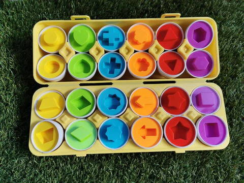 A colorful display of Montessori Geometric Eggs with different shapes and colors. 