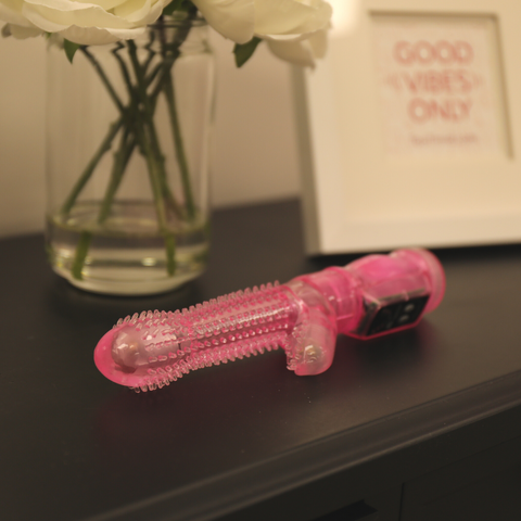Vibrator laying down on bedside table.