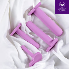 Pink set of anal dilators from Blush Novelties on white sheets