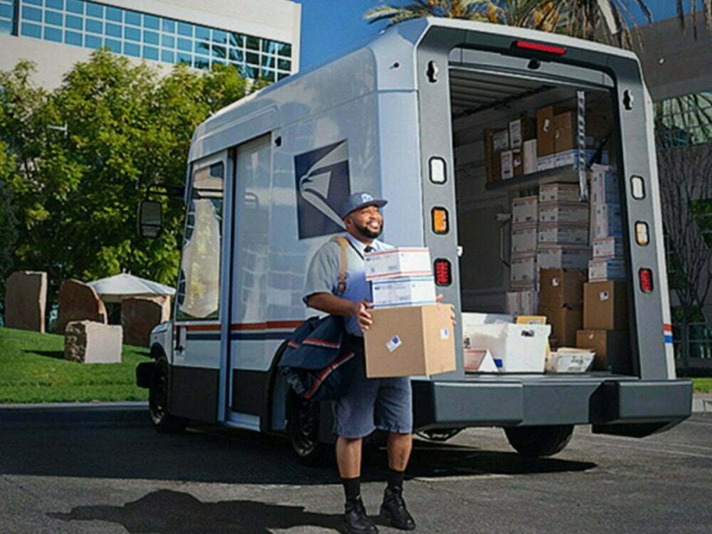 Letter carrier ready to deliver packages unloaded