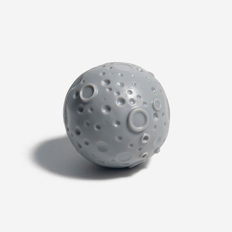 A grey slow feeder ball on the white background.