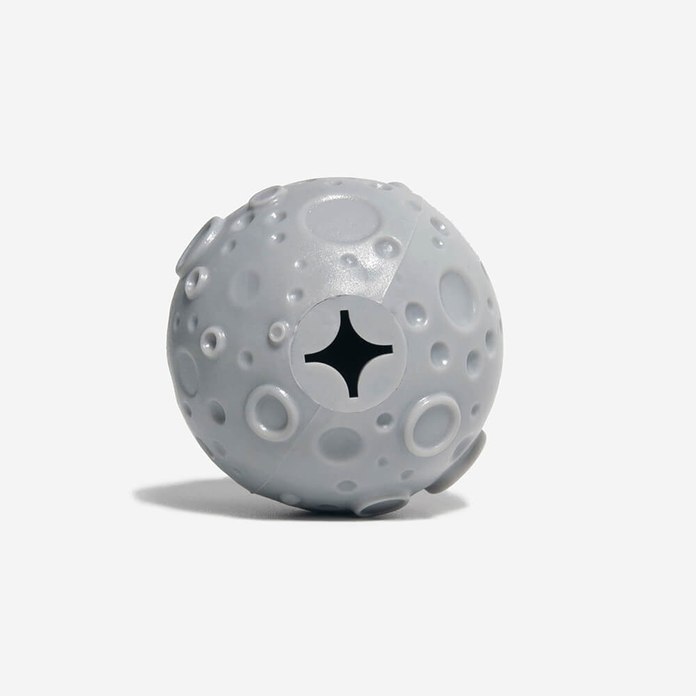 Close up of the bottom of a grey slow feeder ball, it's a hollow and could be used to fill up food.