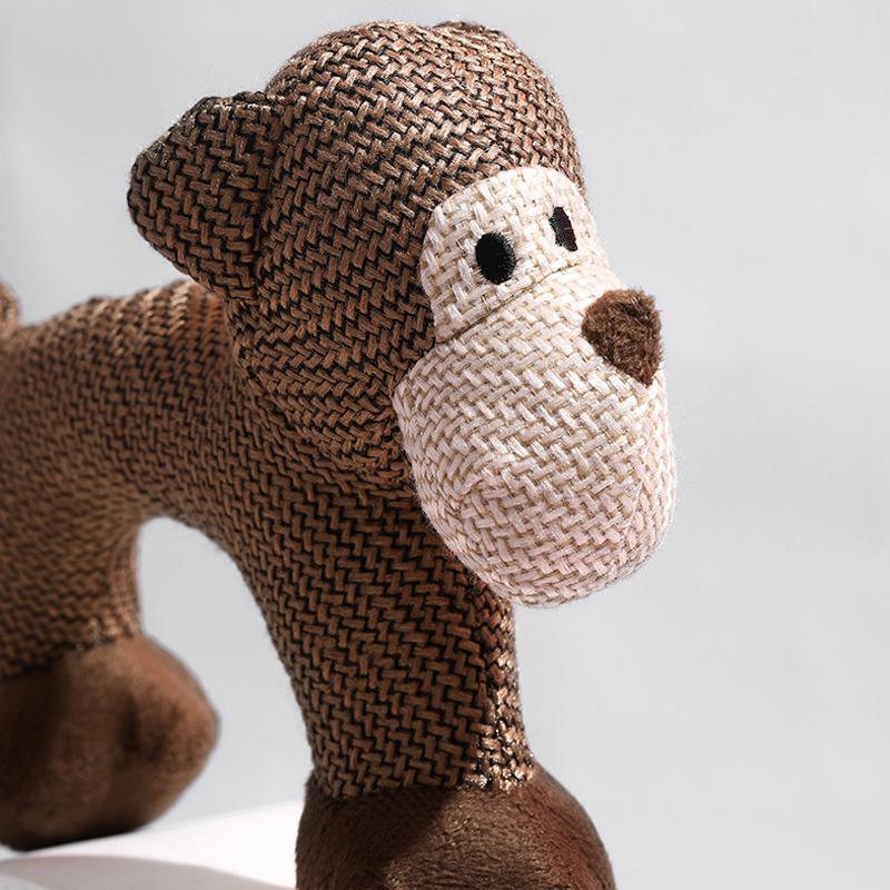 Close up of the face of the monkey dog toy.