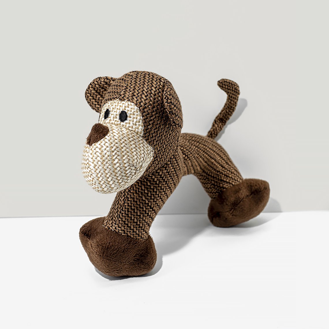 A monkey dog toy on the white background.