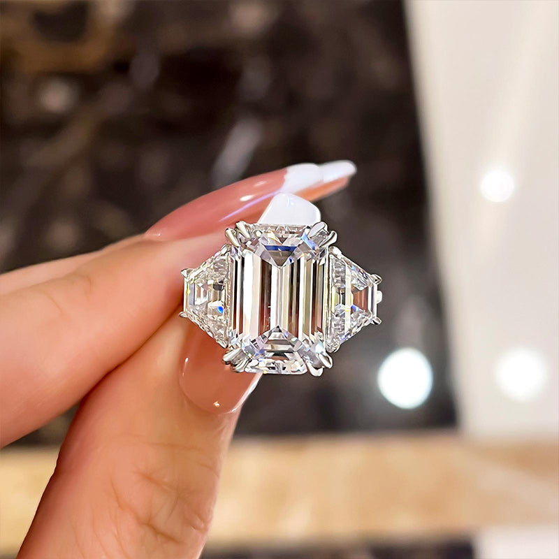 Emerald cut diamond ring with triangle shop side stones