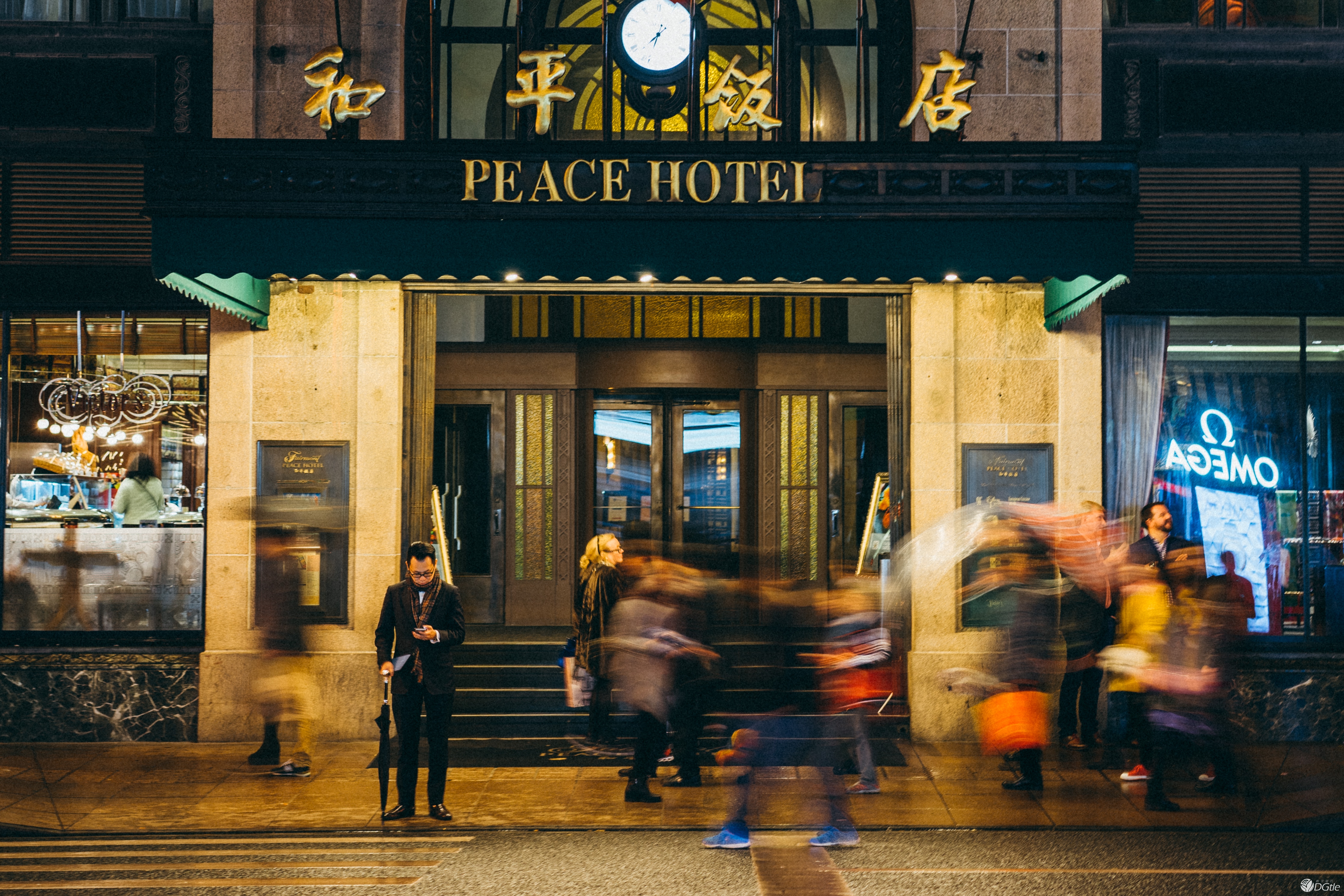 The entrance of the Peace Hotel where people come and go