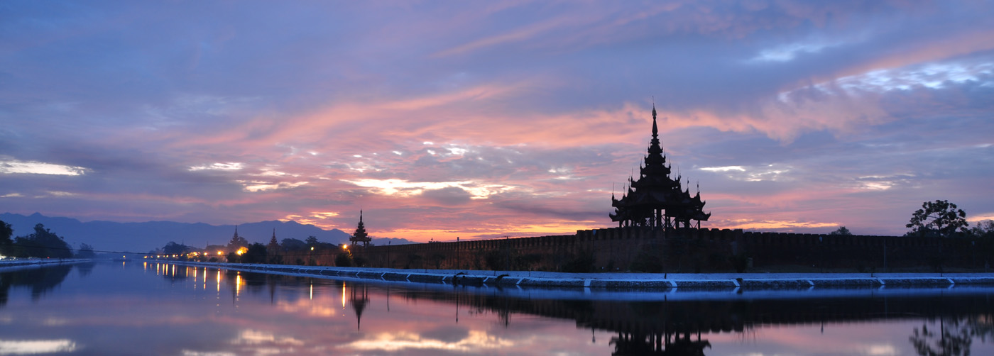 The outskirts of the Mandalay Palace at sunset create an air of mystery