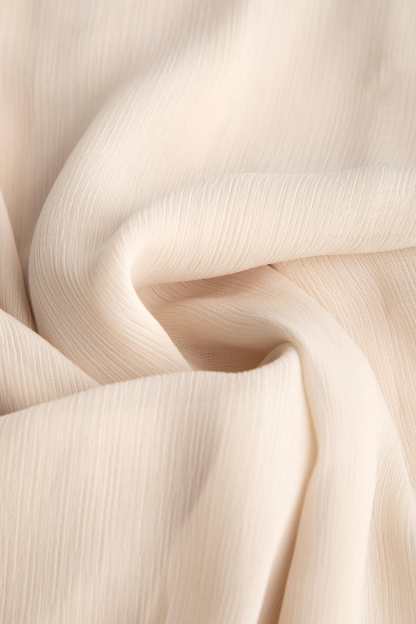Ivory Sleeveless Ruffled Tie Neck Blouse
