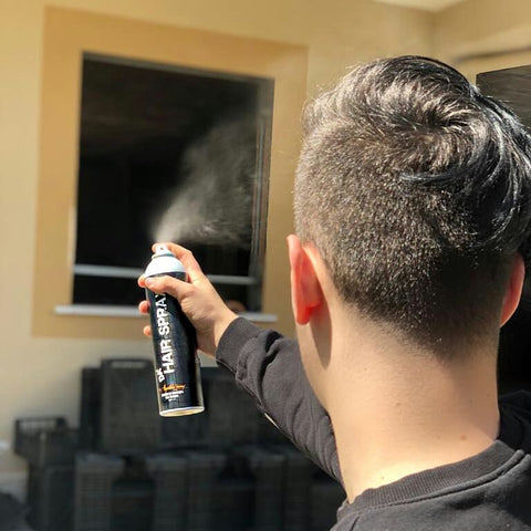 A can of Da'Hair Spray emitting hairstyling mist
