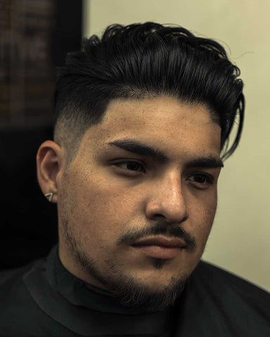 man with big nose rocking the undercut-with-medium-length-on-top hairstyle