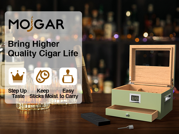 A stylish Mojgar cigar humidor with a hygrometer, alongside whiskey glasses, a cigar, and accessories, promoting a better cigar experience.