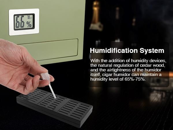 A hand adding moisture to the Mojgar cigar humidor's humidification system, ensuring optimal humidity for cigar storage, with a hygrometer displaying 66%-75%