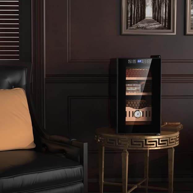 Mojgar 25L Cigar Humidor elegantly placed in a cozy living room setting, showcasing its sleek black design and Spanish cedar wood shelves, perfectly complementing the stylish décor and enhancing the cigar storage experience.
